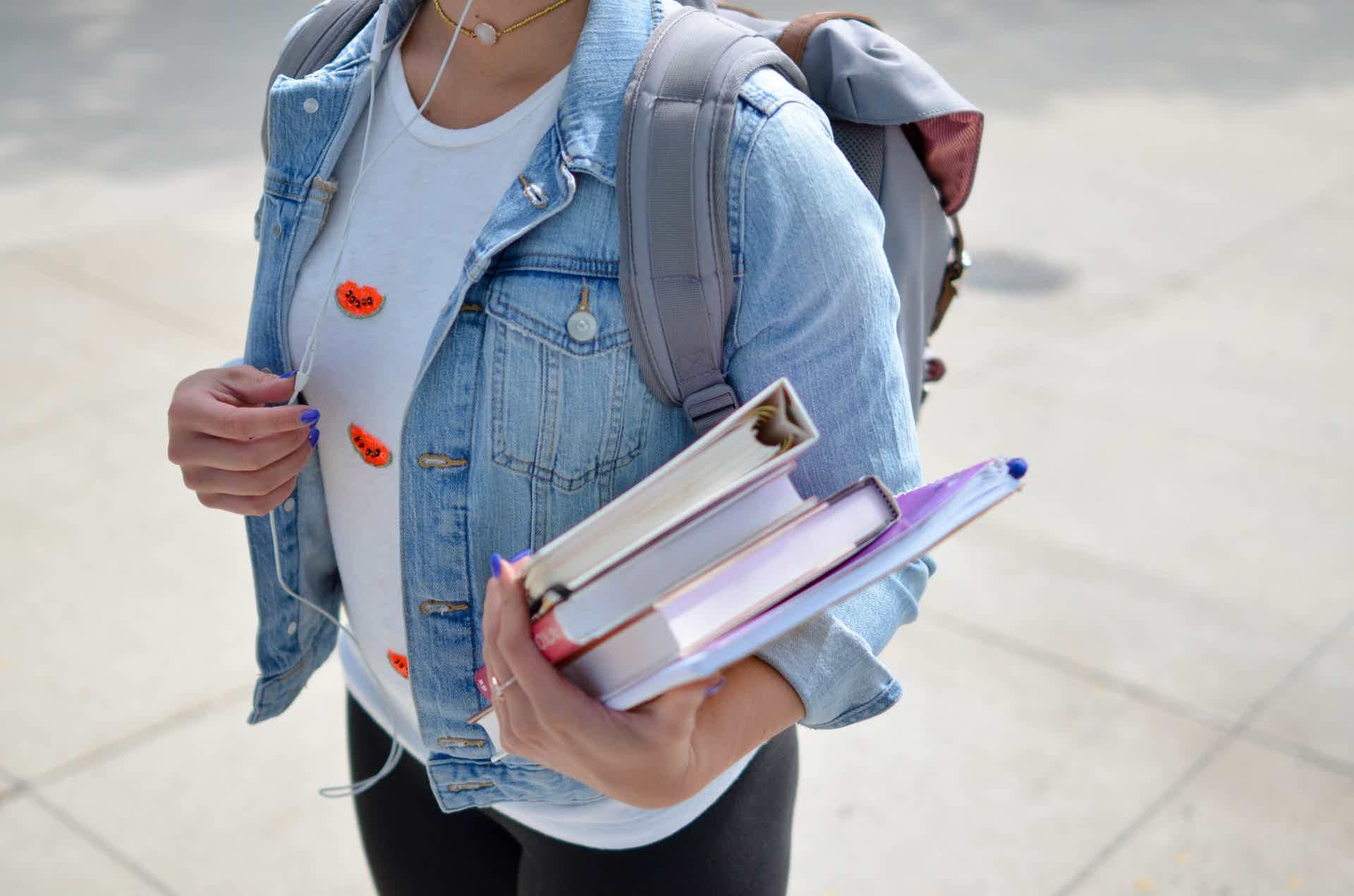 zoom of a student holding books