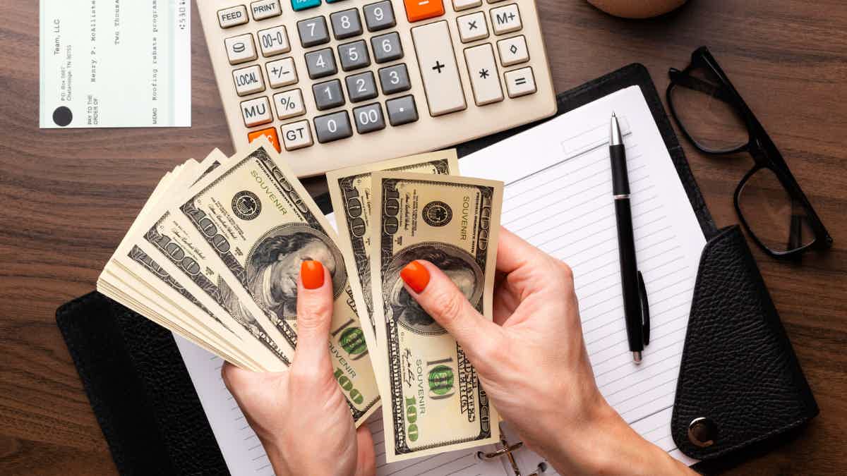 person counting money getting personal loans