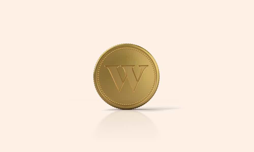 Moeda com logo Wealthsimple Trade fundo bege